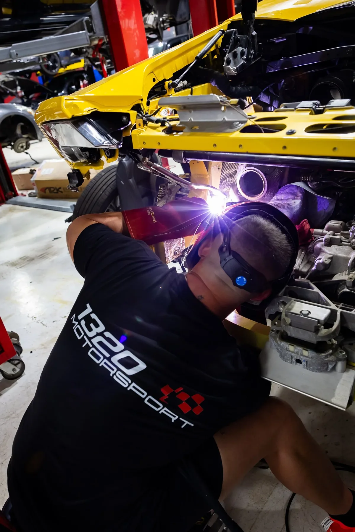 1320Motorsport technician welding on a chassis repair in the Miami shop