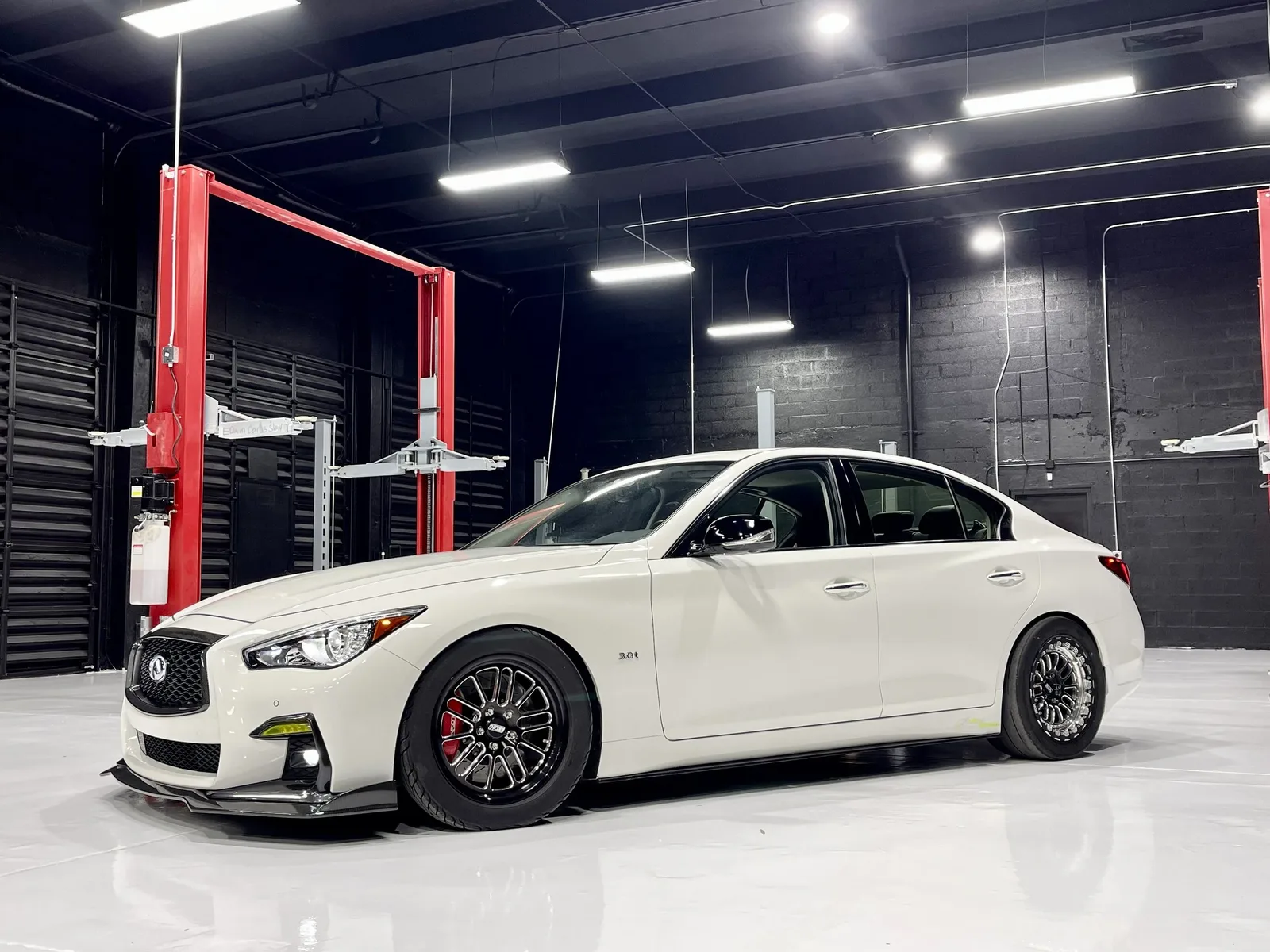 White Infiniti Q50 on the shop floor at 1320Motorsport in Miami